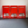 Three Aldo Jacober Red Folding Chairs